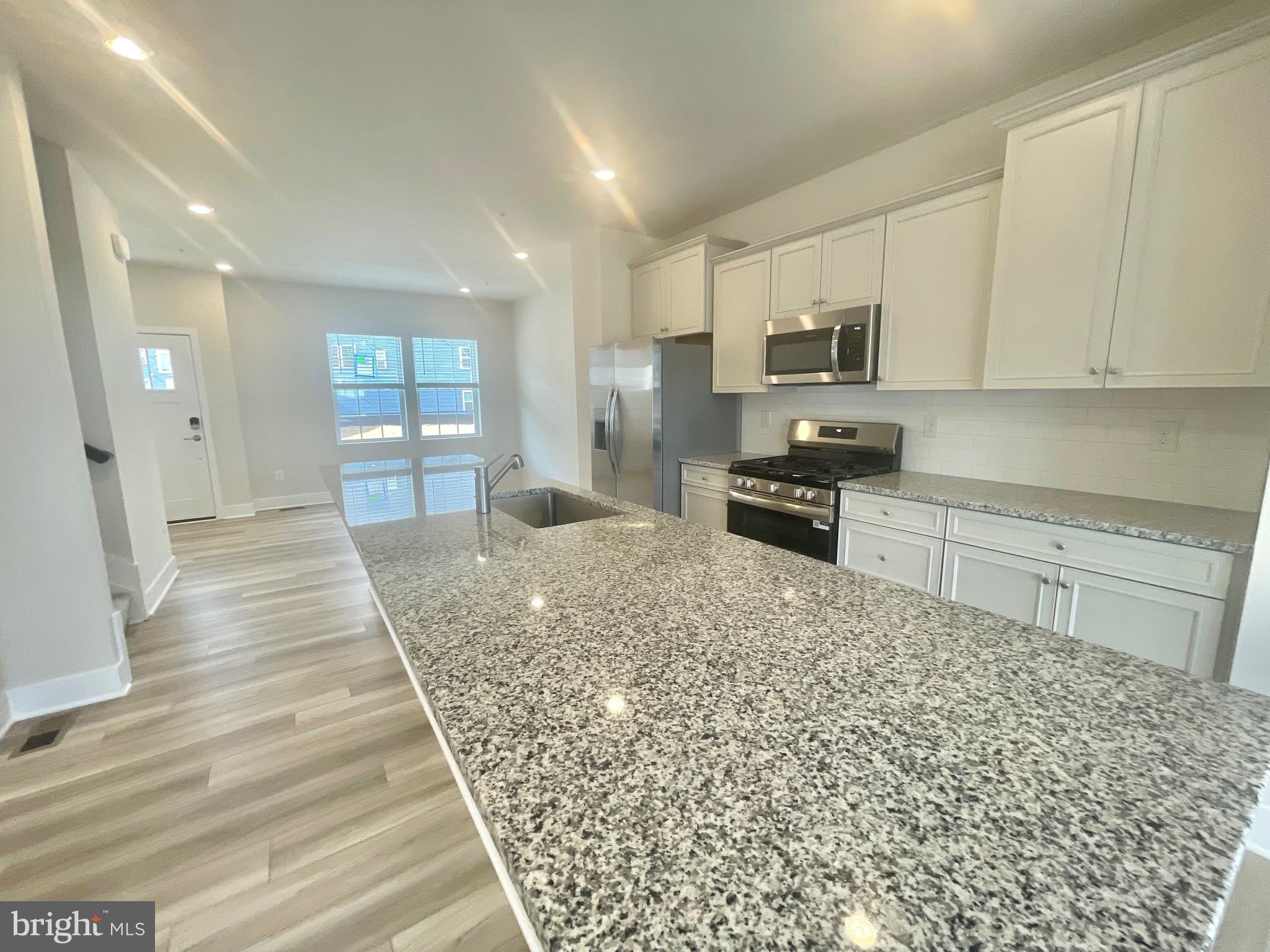 2264 Marcy Drive Frederick, MD 21702 - Photo 10 of 39 a kitchen with stainless steel appliances granite countertop a stove a sink and a refrigerator