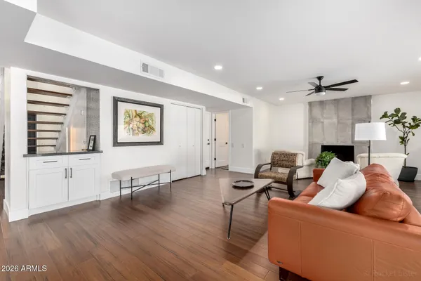 a living room with furniture and wooden floor