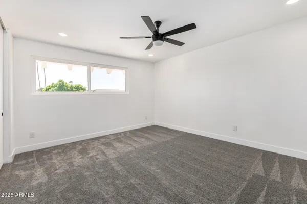 a view of a big room with wooden floor closet and windows