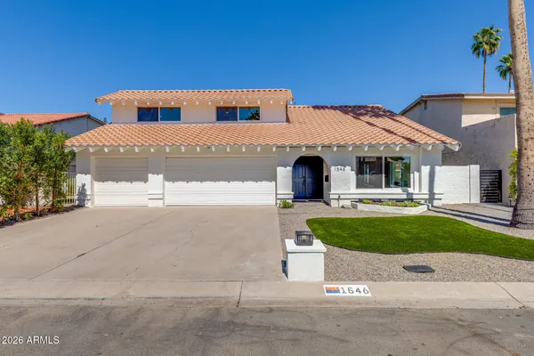 an aerial view of a house with swimming pool and outdoor seating