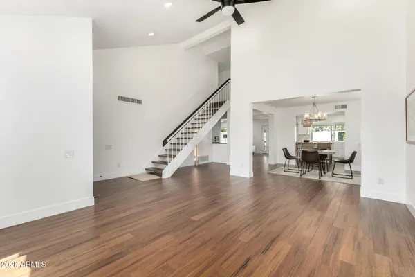 a dining room with furniture a chandelier and wooden floor
