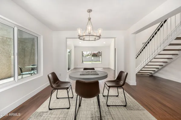 a large kitchen with stainless steel appliances granite countertop a sink stove and refrigerator