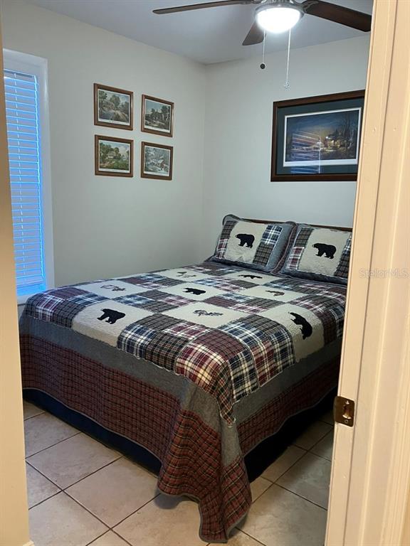 25079 Northeast 140th Loop Salt Springs, FL 32134 - Photo 12 of 23 a bed sitting in a bedroom next to a window