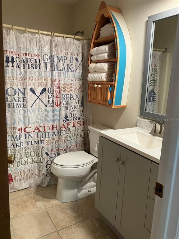 25079 Northeast 140th Loop Salt Springs, FL 32134 - Photo 14 of 23 a bathroom with a toilet sink and mirror