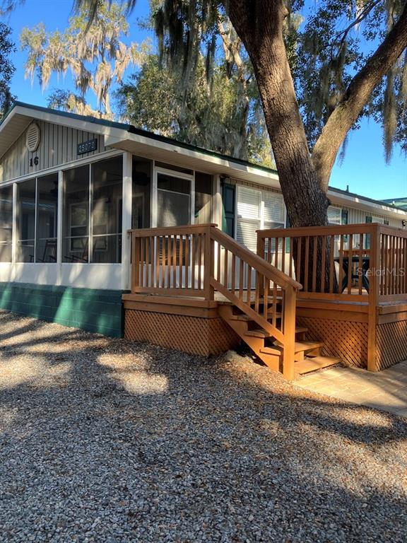 25079 Northeast 140th Loop Salt Springs, FL 32134 - Photo 4 of 23 a view of a house with backyard and a tree