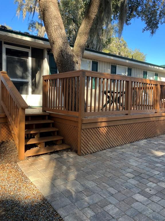 25079 Northeast 140th Loop Salt Springs, FL 32134 - Photo 6 of 23 a view of a deck with a floor to ceiling window and wooden fence