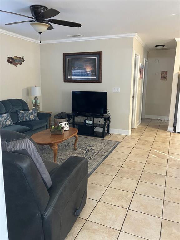 25079 Northeast 140th Loop Salt Springs, FL 32134 - Photo 9 of 23 a living room with patio furniture and a flat screen tv
