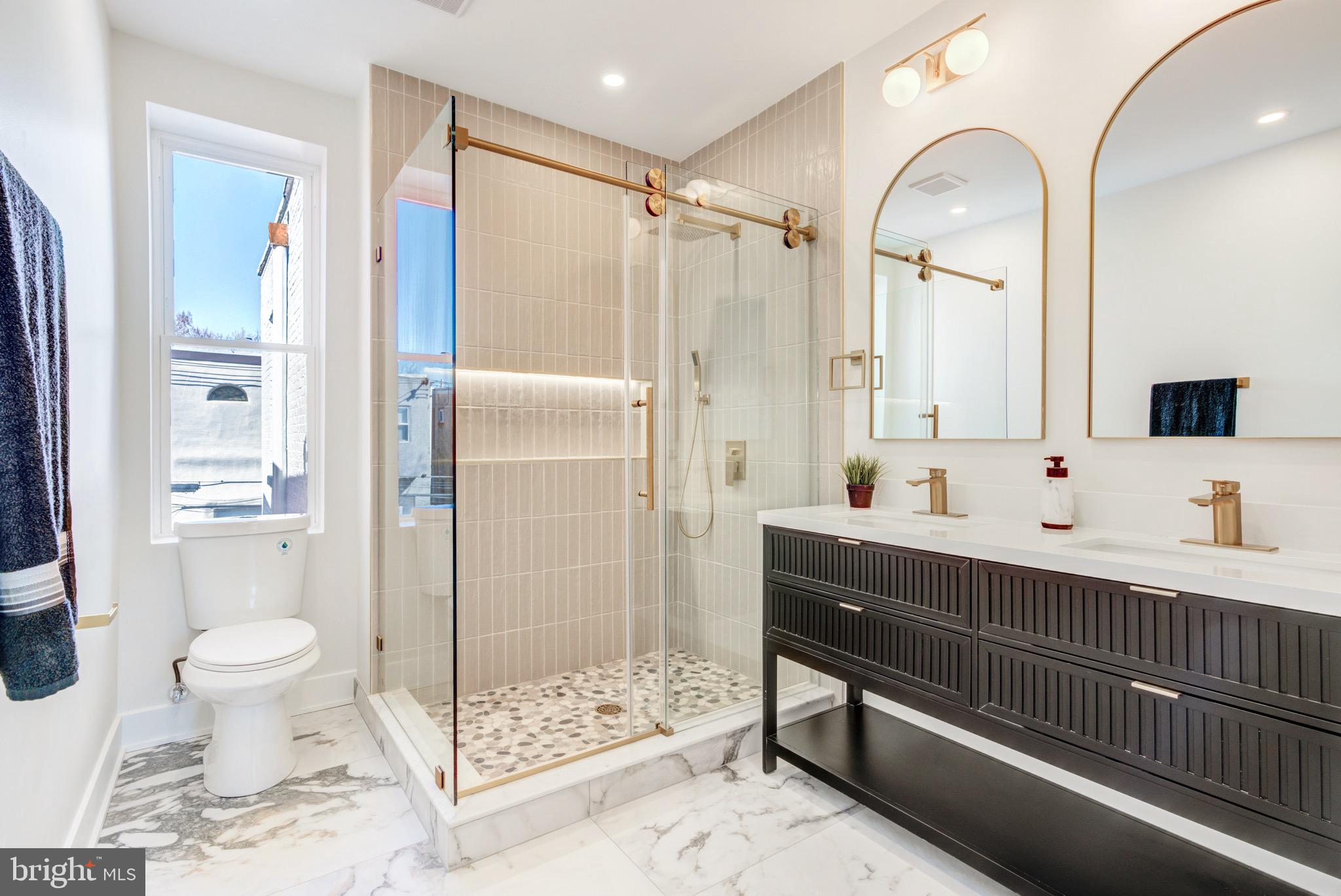 1924 South Lambert Street Philadelphia, PA 19145 - Photo 24 of 35 a bathroom with a double vanity sink toilet and shower