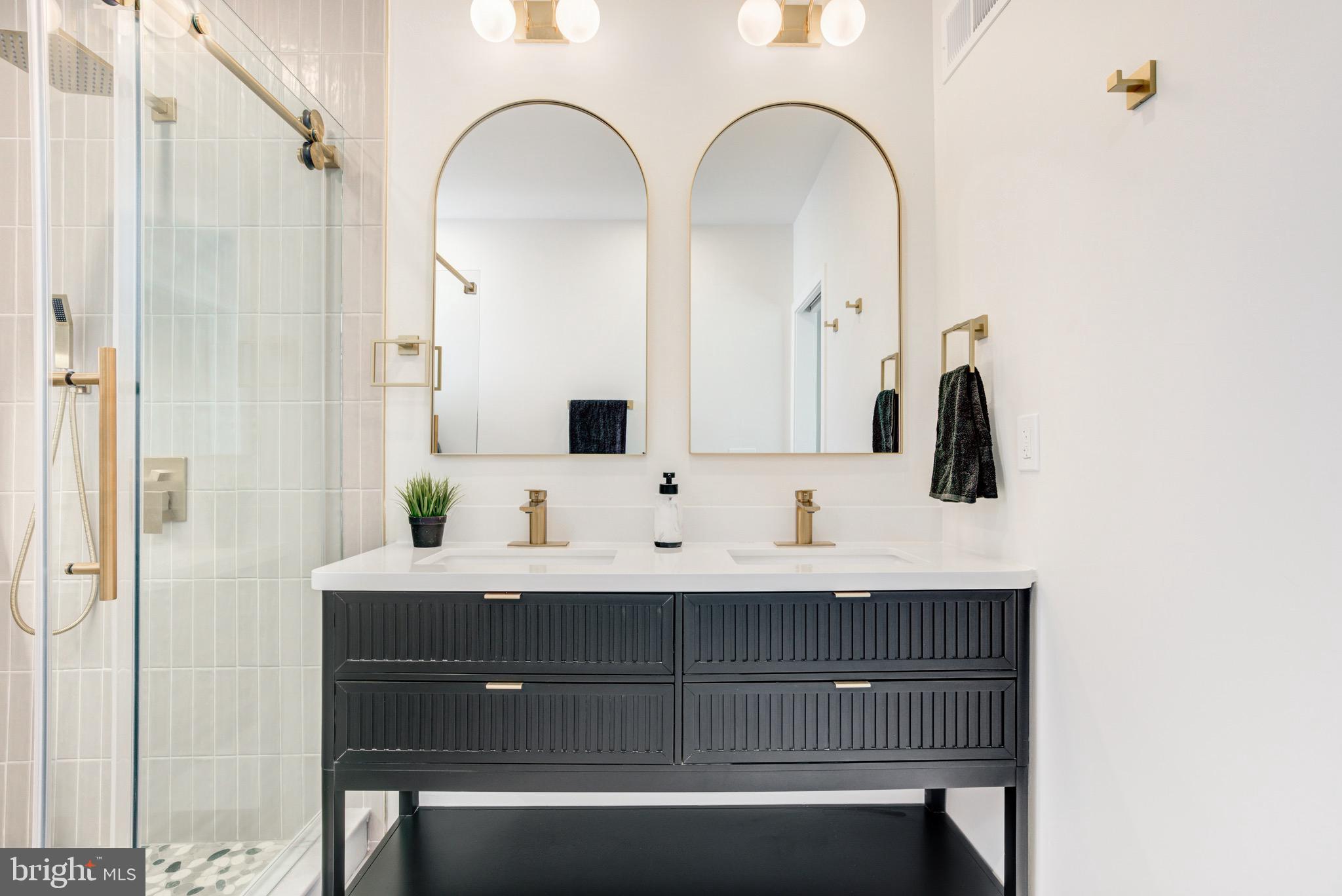 1924 South Lambert Street Philadelphia, PA 19145 - Photo 25 of 35 a bathroom with a double vanity sink and mirror