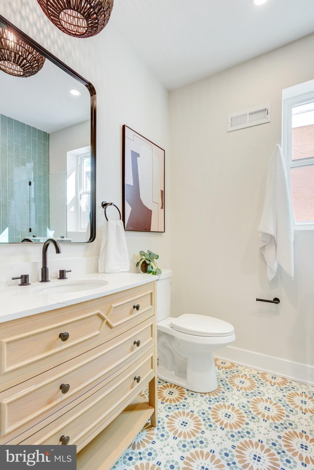 1924 South Lambert Street Philadelphia, PA 19145 - Photo 28 of 35 a bathroom with a sink a toilet and a mirror