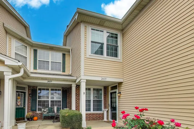 a view of building with a window and potted plants
