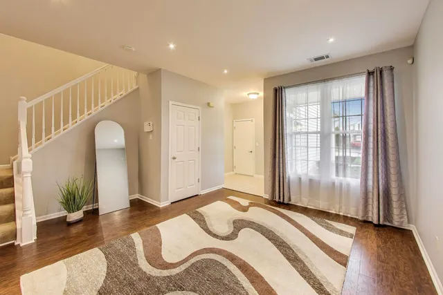 a bedroom with bed and a large window