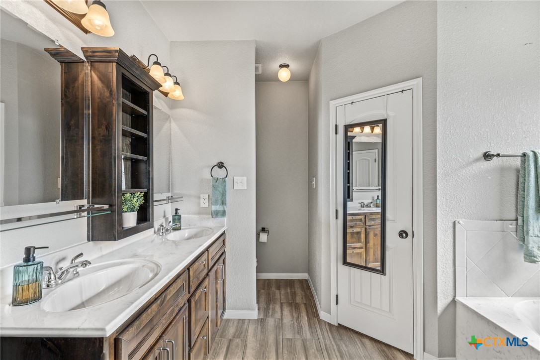 3437 Samuel Street Copperas Cove, TX 76522 - Photo 26 of 31 a bathroom with a granite countertop sink and a mirror