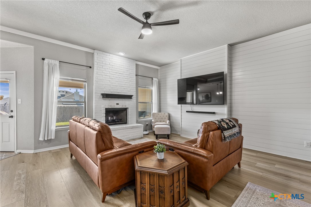 3437 Samuel Street Copperas Cove, TX 76522 - Photo 7 of 31 a living room with fireplace furniture and a wooden floor