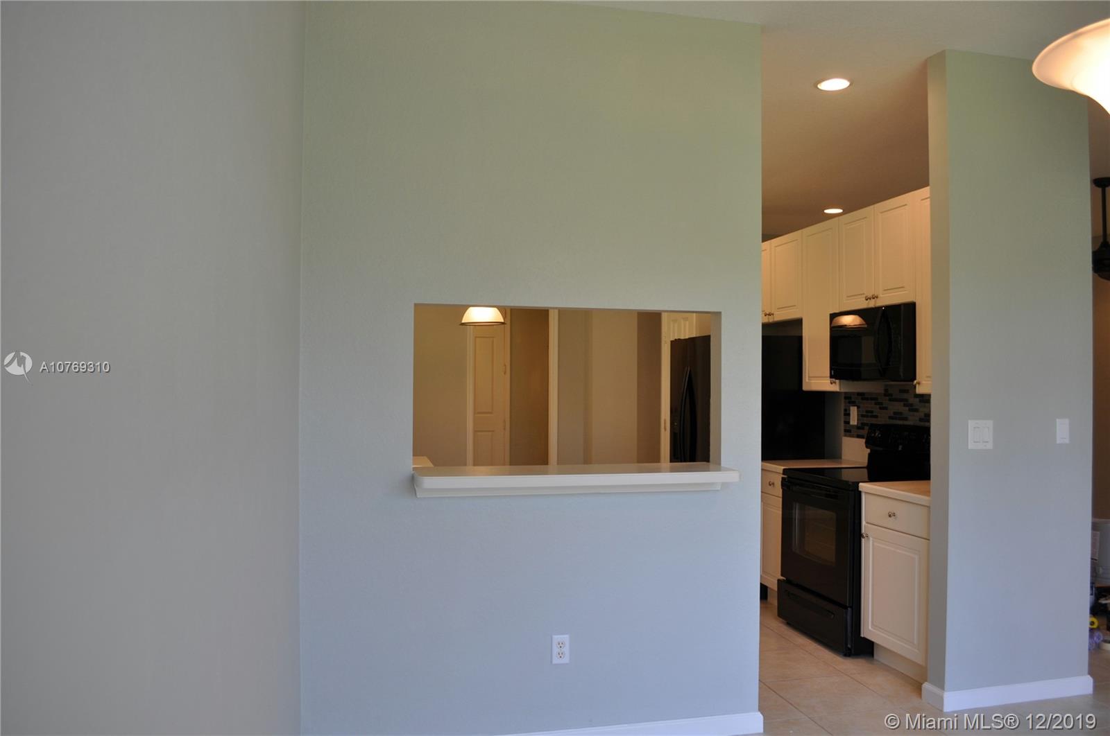 332 Southwest Otter Run Place, Unit 332 Stuart, FL 34997 - Photo 11 of 24 Pass thru from the kitchen to the dining room.