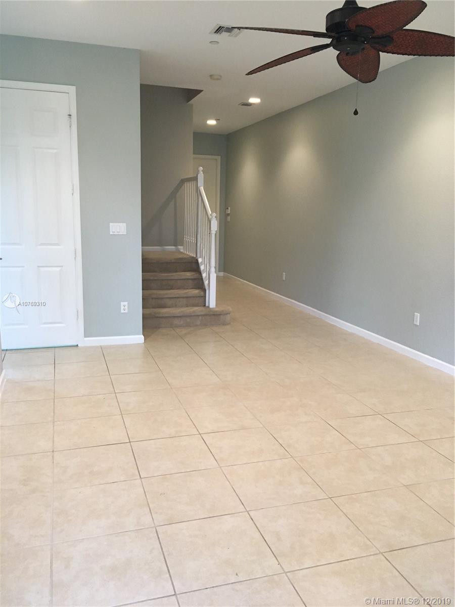 332 Southwest Otter Run Place, Unit 332 Stuart, FL 34997 - Photo 12 of 24 Stairs to second floor. View of the half bath on the main floor