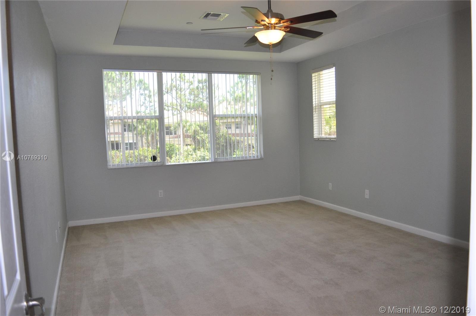332 Southwest Otter Run Place, Unit 332 Stuart, FL 34997 - Photo 15 of 24 Master suite with tray ceilings, big windows and a large walk in closet.