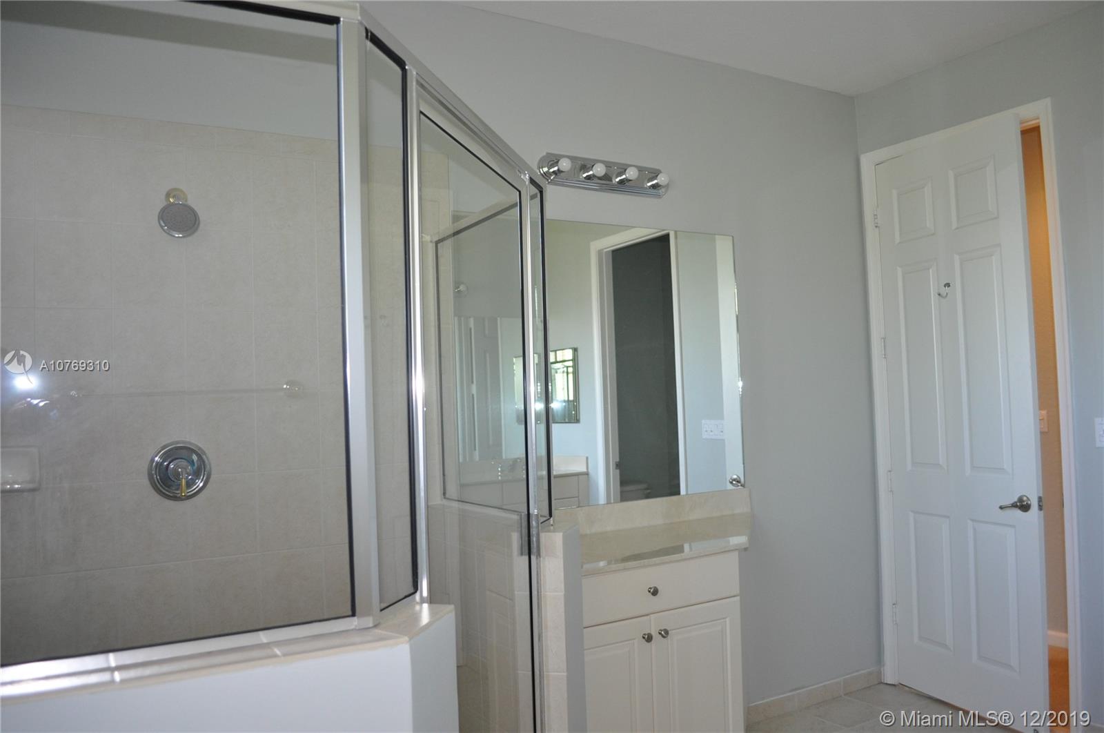 332 Southwest Otter Run Place, Unit 332 Stuart, FL 34997 - Photo 18 of 24 View of the shower and the extra counter and cabinet. Lots of room to prepare for the day.