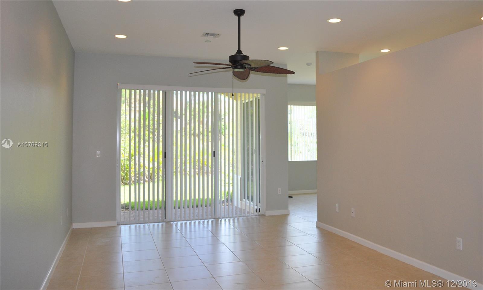 332 Southwest Otter Run Place, Unit 332 Stuart, FL 34997 - Photo 4 of 24 living room with sliders to the patio and backyard.