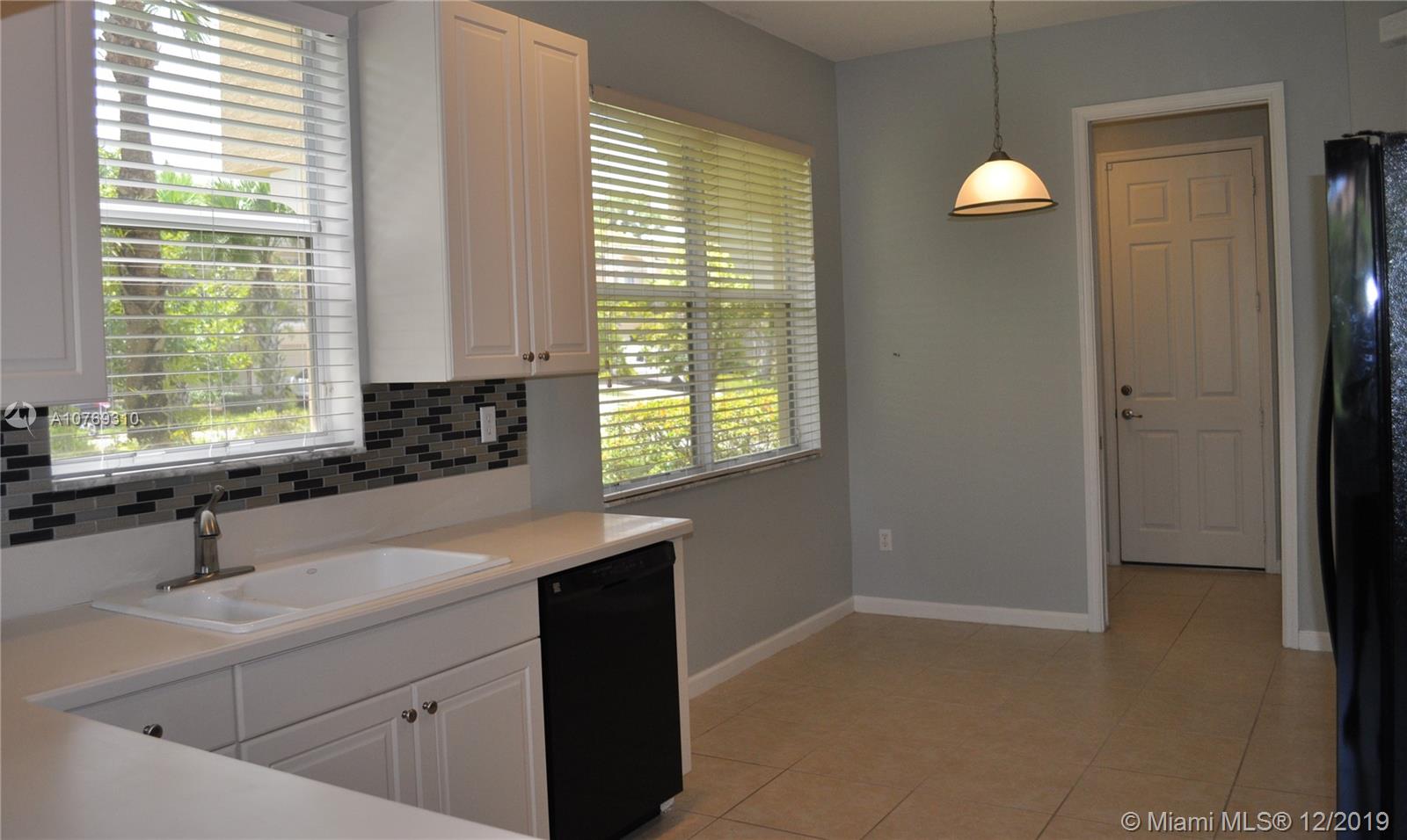 332 Southwest Otter Run Place, Unit 332 Stuart, FL 34997 - Photo 6 of 24 Big windows in this end unit brightens the breakfast nook.