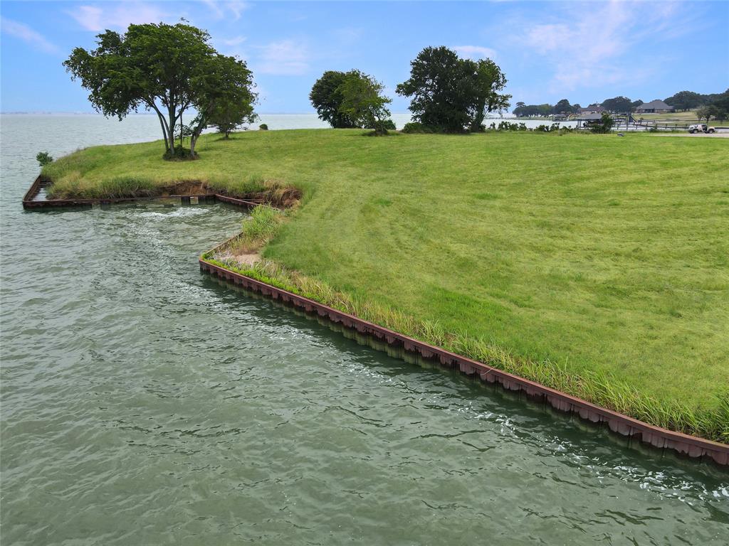 Lot 19 Lake Ridge Drive Streetman, TX 75859 - Photo 21 of 40 a view of a lake with a building in the background