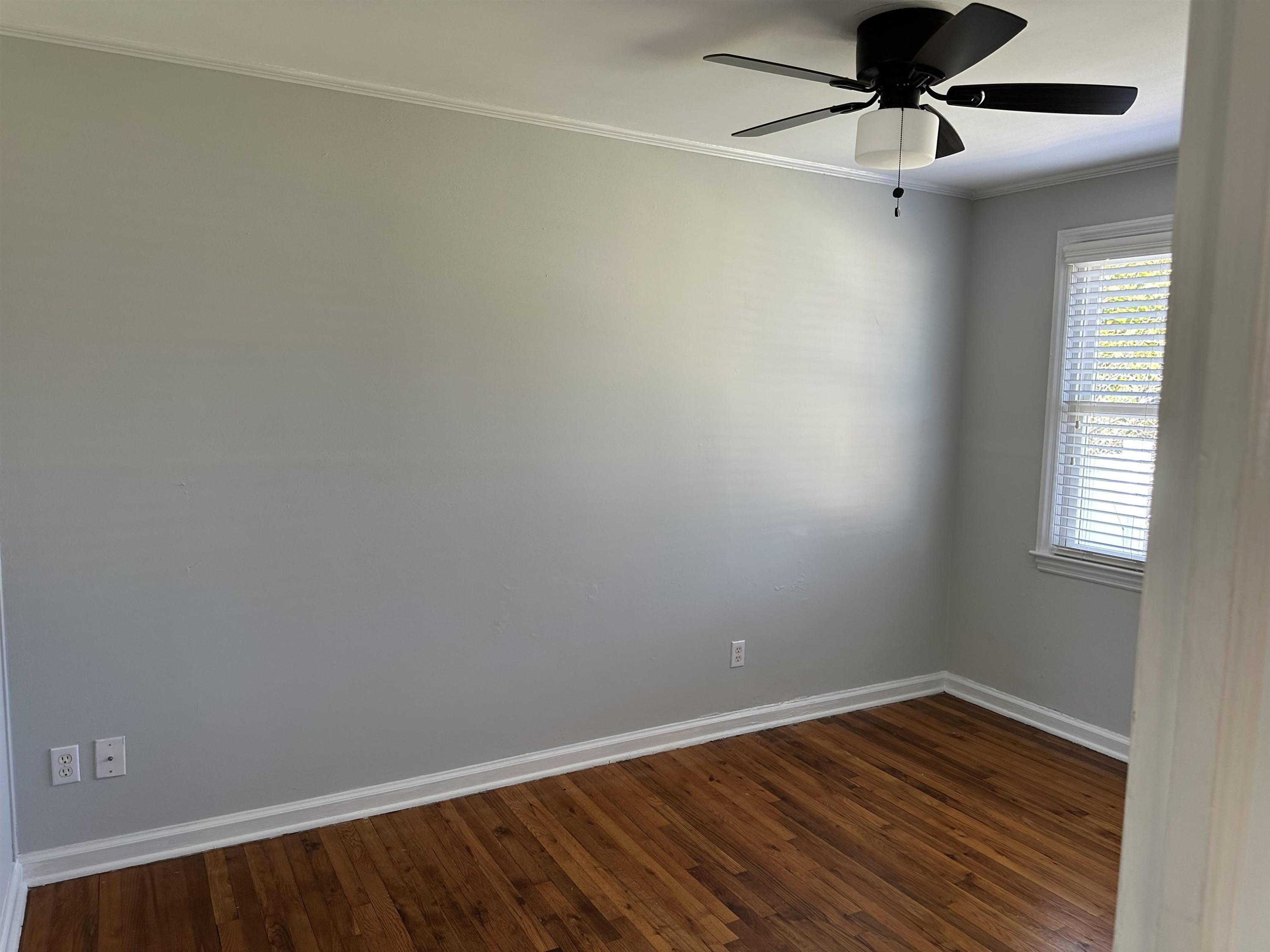 2344 Bernard Street, Unit 3 Raleigh, NC 27608 - Photo 13 of 15 an empty room with a window and wooden floor