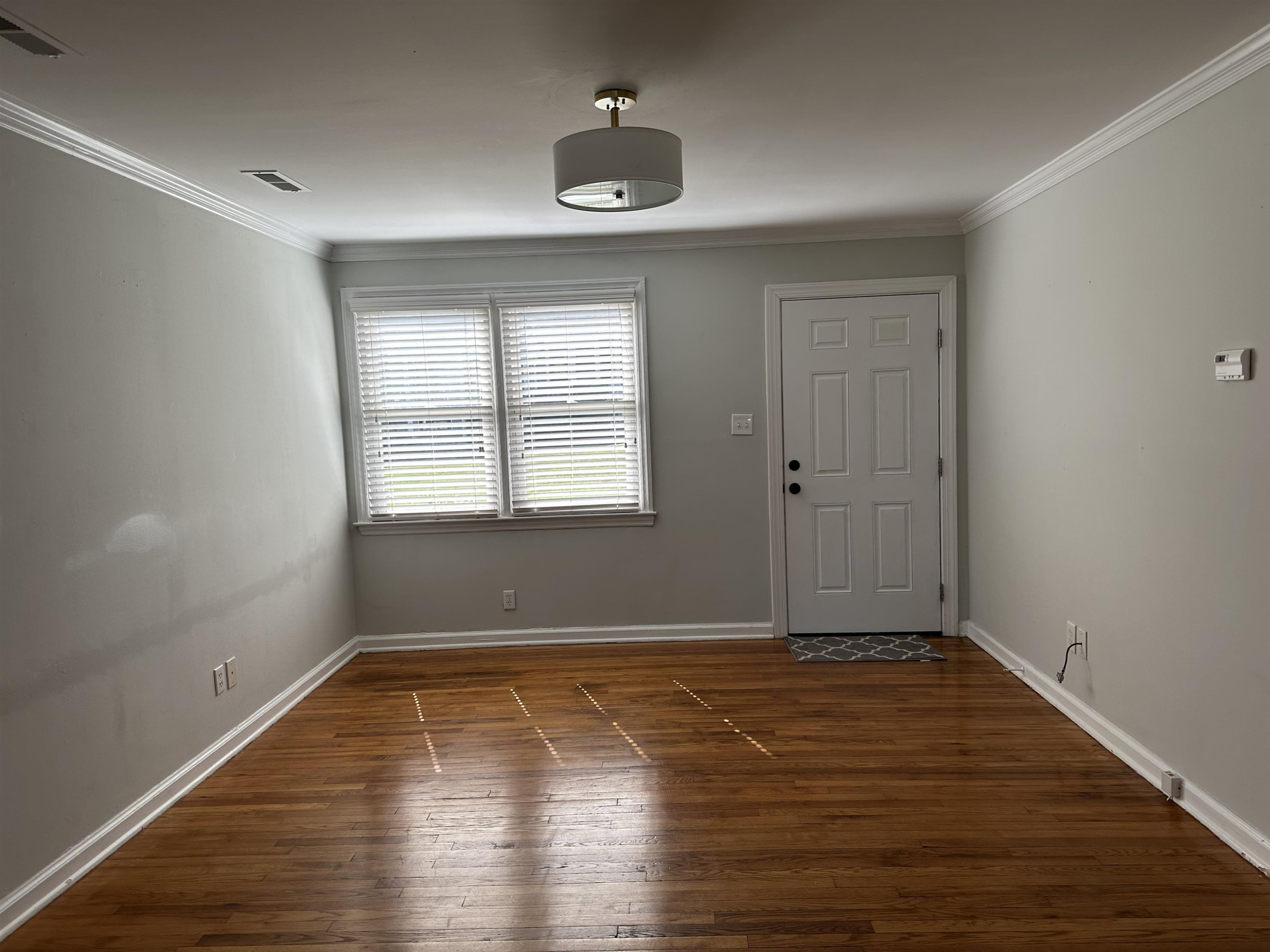 2344 Bernard Street, Unit 3 Raleigh, NC 27608 - Photo 3 of 15 wooden floor in an empty room with a window