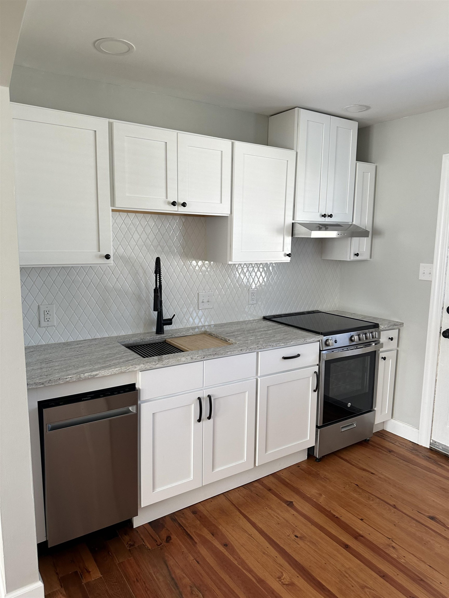 2344 Bernard Street, Unit 3 Raleigh, NC 27608 - Photo 4 of 15 a kitchen with granite countertop white cabinets and white appliances