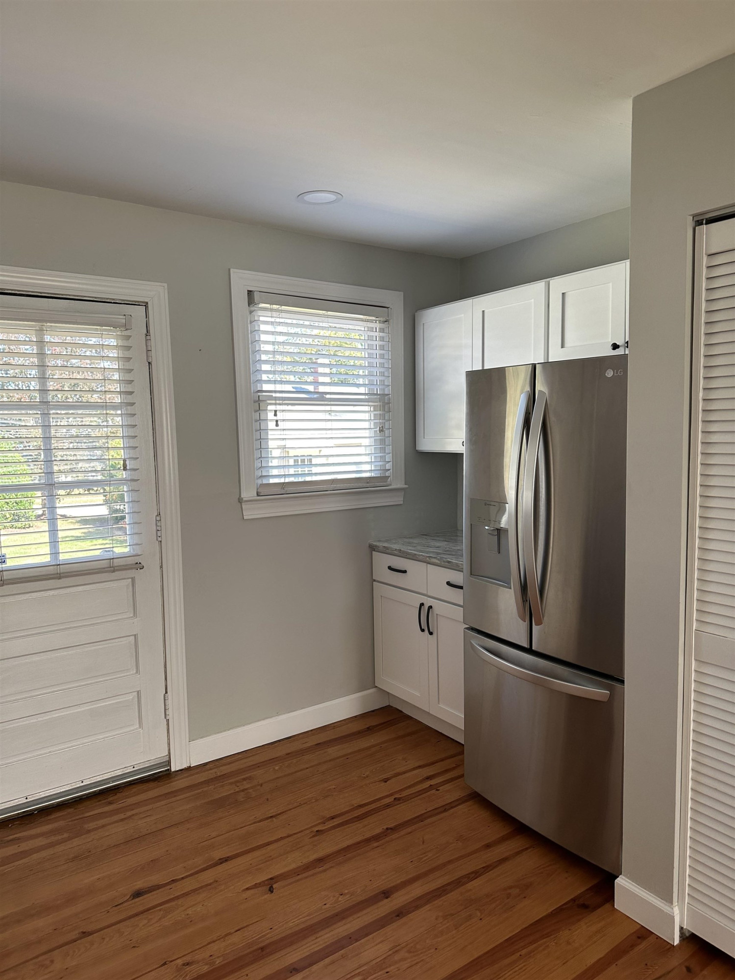 2344 Bernard Street, Unit 3 Raleigh, NC 27608 - Photo 6 of 15 a kitchen with stainless steel appliances a refrigerator and wooden floor