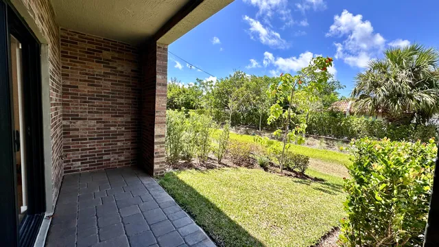 a view of balcony with wooden floor and a yard