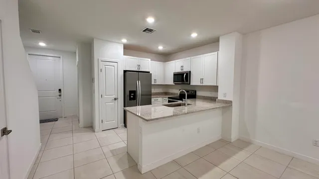 a kitchen with appliances cabinets and a sink