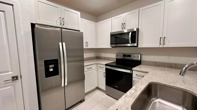 a kitchen with a refrigerator sink and microwave