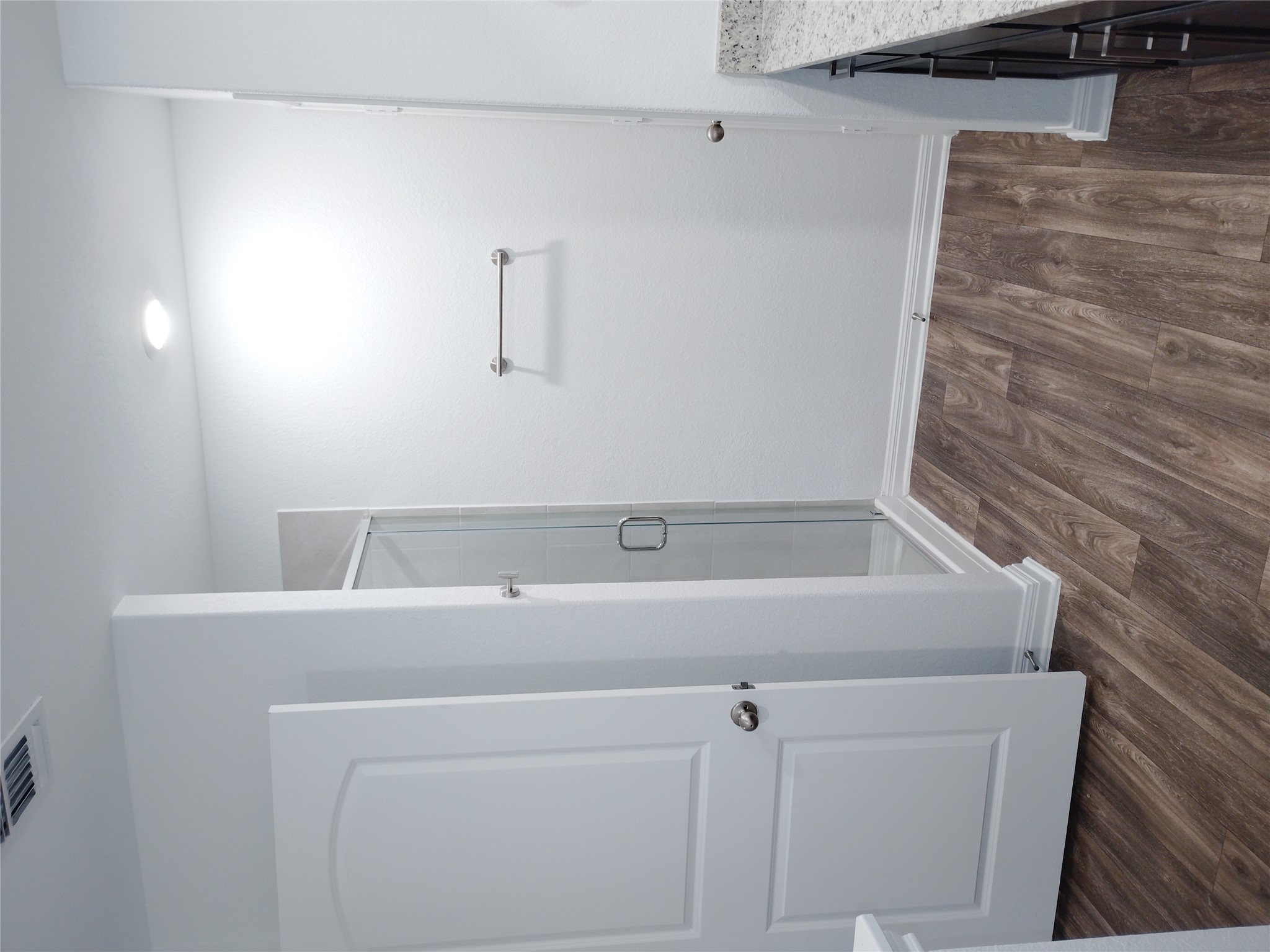 14024 Prairie Schooner Pass Elgin, TX 78621 - Photo 12 of 20 Bathroom featuring a glass-enclosed shower, wood-finish flooring, and white baseboards