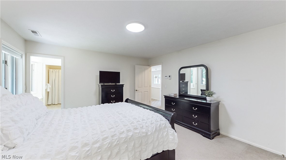 3700 Chagrin River Road Chagrin Falls, OH 44022 - Photo 21 of 43 Bedroom 3 with multiple windows and light colored carpet and bright bathroom