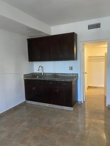a room with a sink and a flat screen tv