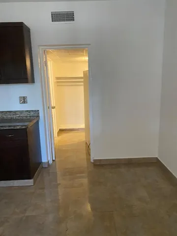 a view of a kitchen with a sink and a window