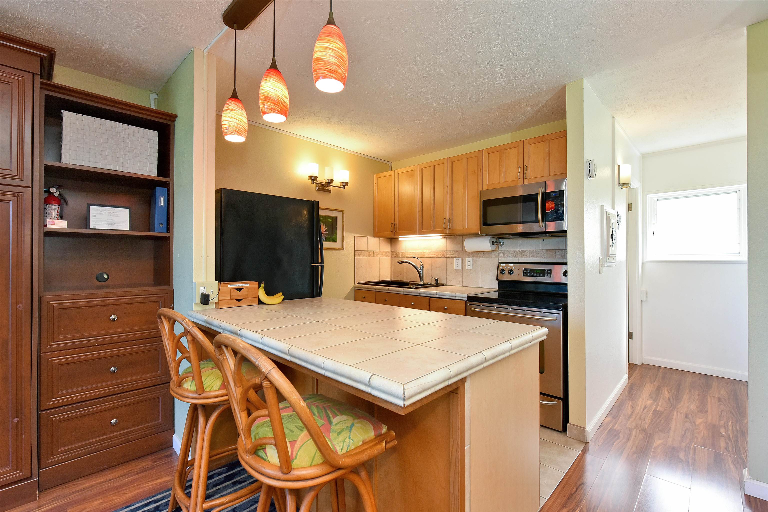 120 Hui Rd F, Unit K 11 Lahaina, HI 96761 - Photo 7 of 47 a kitchen with a appliances a refrigerator and a stove top oven