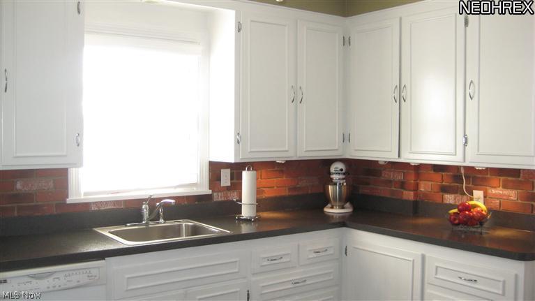 4154 Silsby Road University Heights, OH 44118 - Photo 9 of 18 Newer white cabinets, countertops, flooring, sink and more.