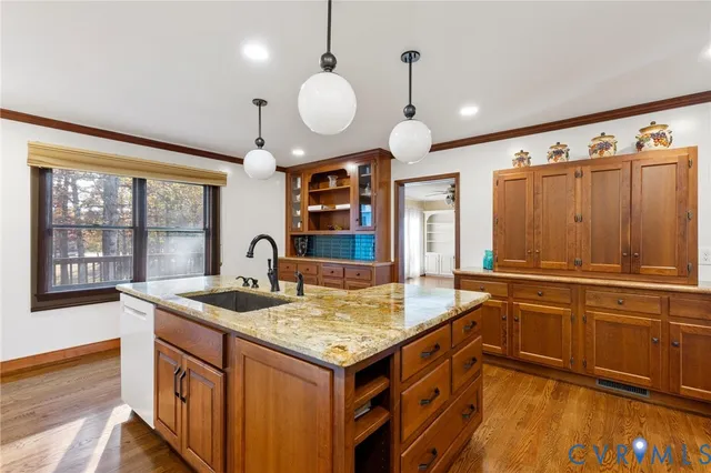 a view of a livingroom with wooden floor and a ceiling fan