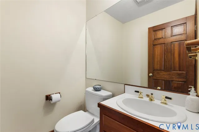 an empty room with chandelier fan and windows