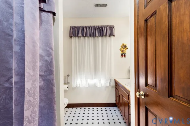 a view of a livingroom with wooden floor and a hallway