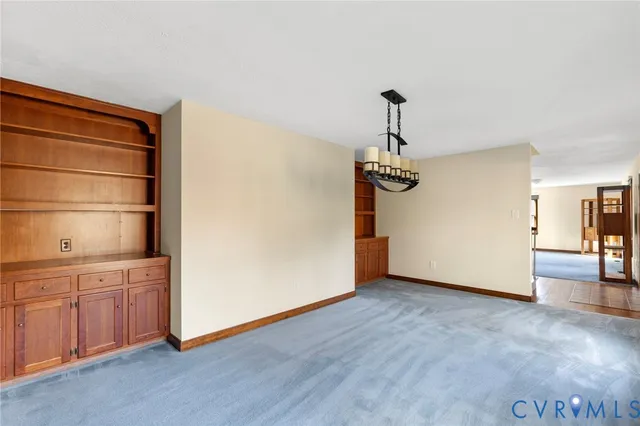 a kitchen with a stove center island a sink cabinets and wooden floor