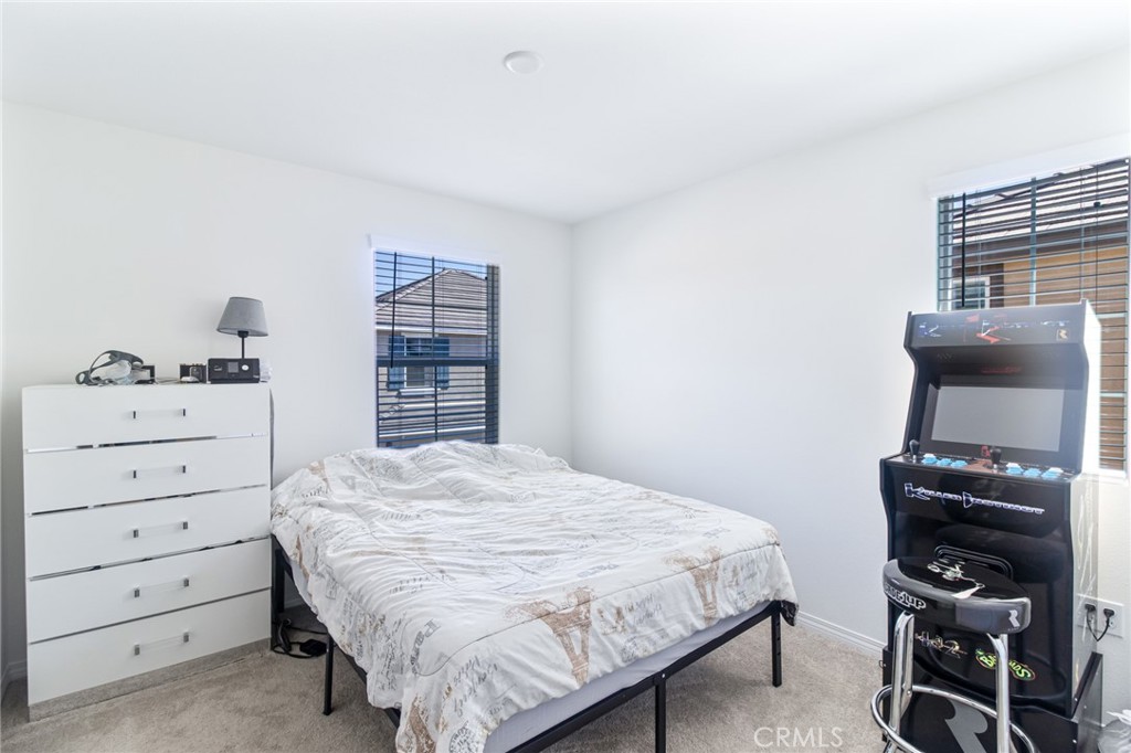 2448 Powell Drive Rialto, CA 92377 - Photo 14 of 30 a bedroom with a bed and a closet