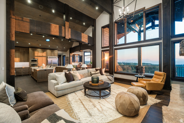 9156 Forest Road, Unit 24 Heber City, UT 84036 - Photo 13 of 42 Open concept living space featuring a two-story ceiling, exposed wood beams, and dark wood-finish flooring