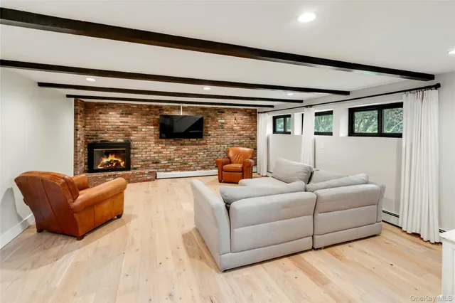 a bedroom with furniture and a flat screen tv