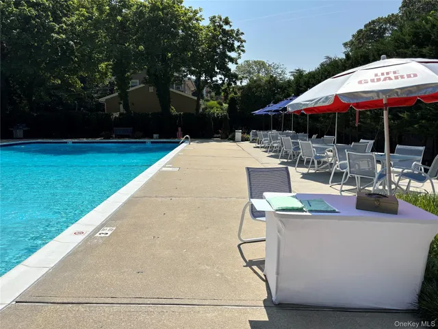 a view of backyard with outdoor seating and green space