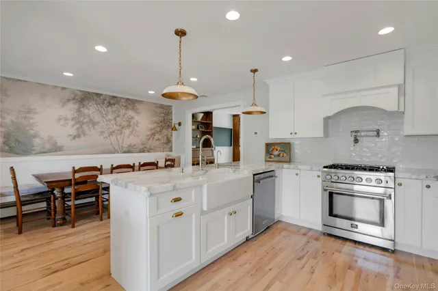 a kitchen with stainless steel appliances a stove sink and cabinets