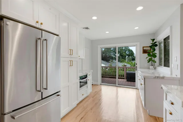 a kitchen with stainless steel appliances granite countertop a refrigerator and a sink