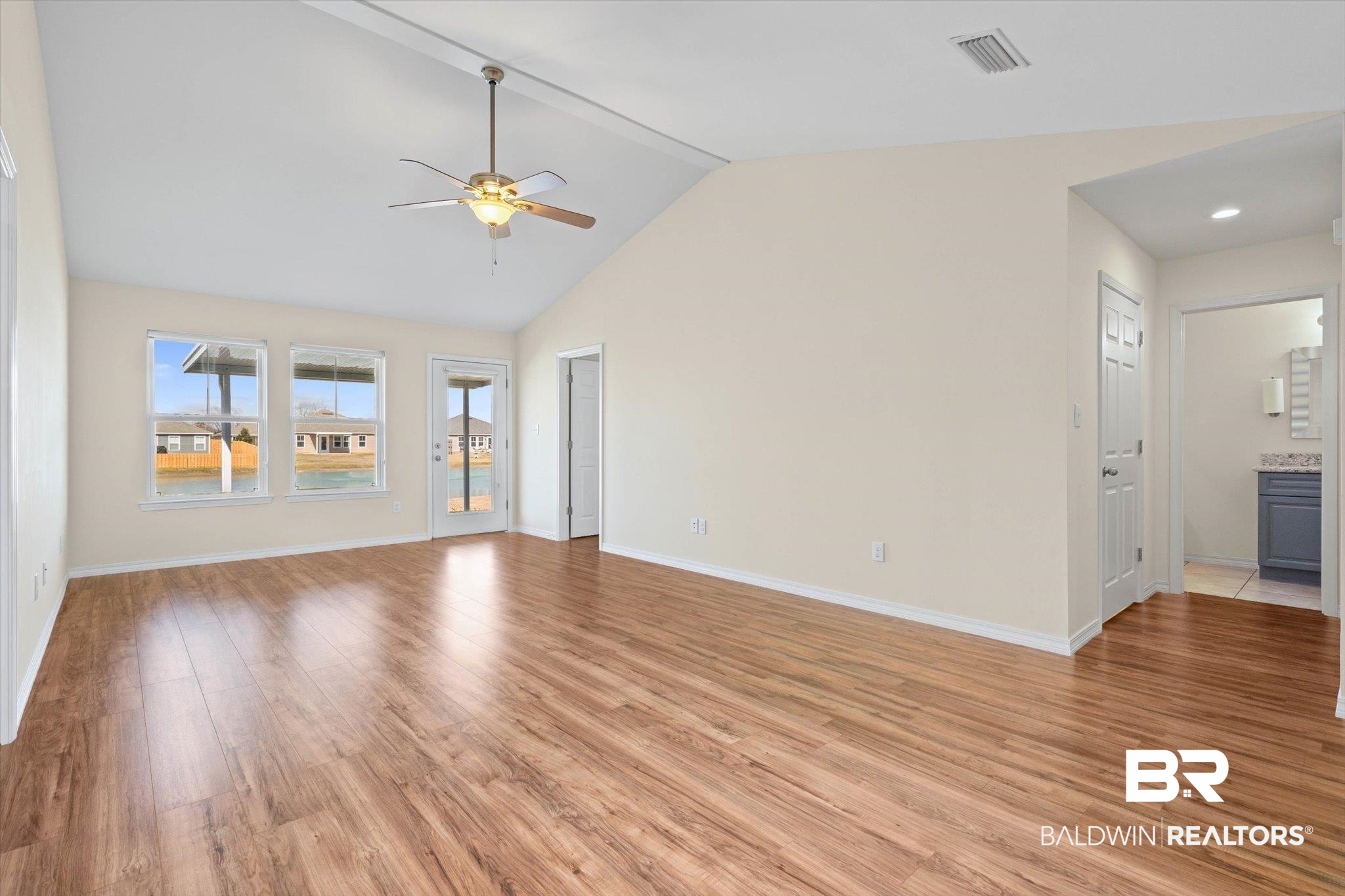 919 Sailor Circle Foley, AL 36535 - Photo 3 of 24 Unfurnished living room featuring light wood-style flooring, a ceiling fan, and a high ceiling