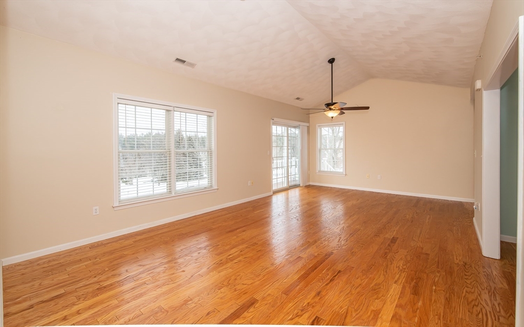 401 Autumn Ridge Drive, Unit 401 Ayer, MA 01432 - Photo 11 of 33 a view of an empty room with wooden floor and a window